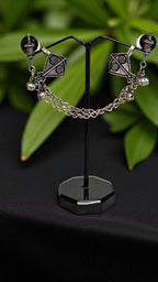 Intricately Designed Silver Kite Cuff with Delicate Chain Links and Decorative Bells